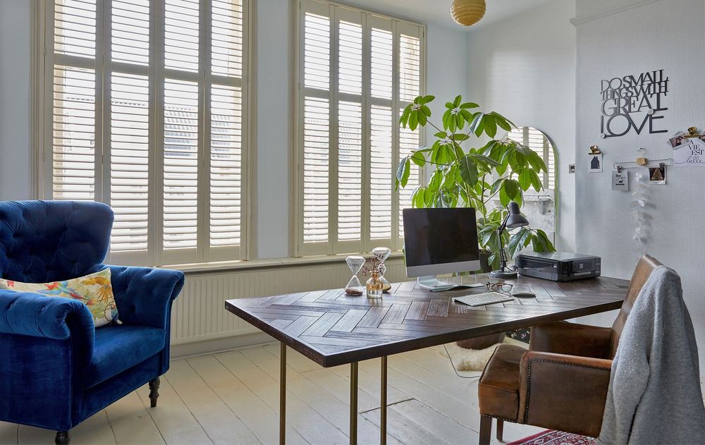 Cream Brightwood™ shutters on tall home office windows