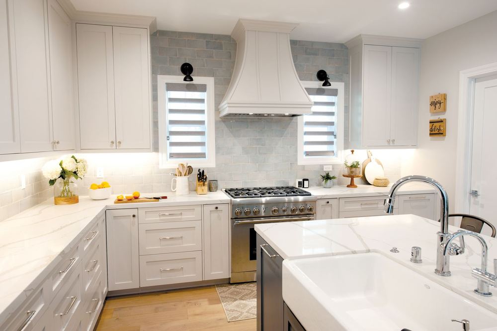 Grey PerfectSheer™ shades on two kitchen windows beside a range hood