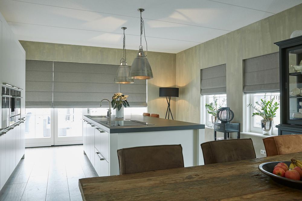 Grey Roman shades over kitchen patio doors and windows