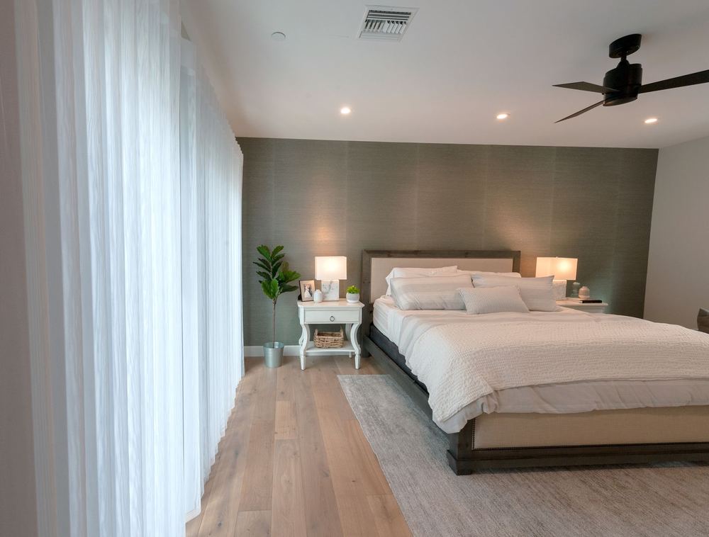 White SmartDrape® panels along a bedroom window wall