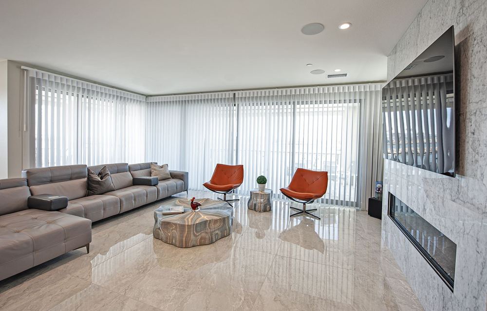 Pale grey SmartDrape® panels wrapping a corner of windows
