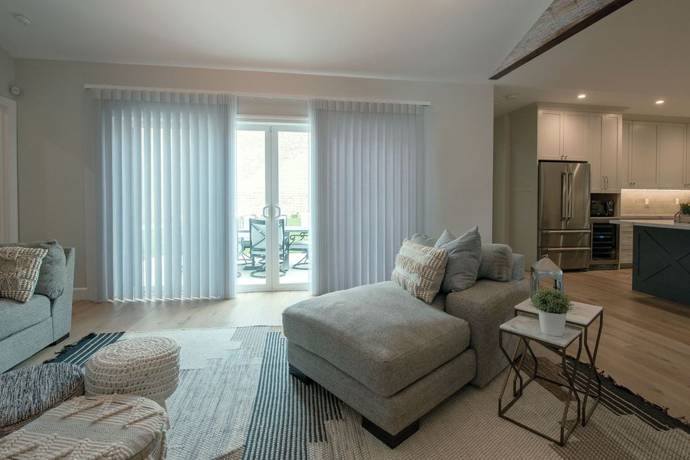 White SmartDrape® panels flanking French doors in an open-plan living room